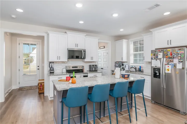 Gleaming stone countertops and recessed lighting elevate this modern culinary space.