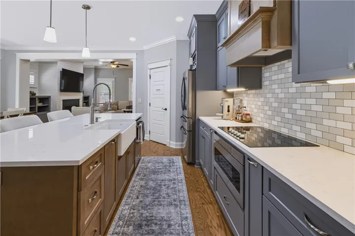 Timeless finishes are seen throughout - Craftsman trim framing windows & doors in all main living areas, along with hardwood flooring and crown molding.