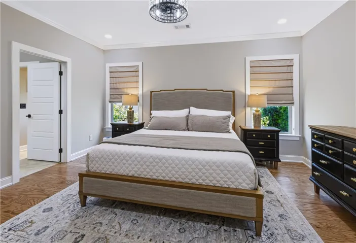 Gleaming hardwood floors and classic crown molding define this Primary Bedroom.