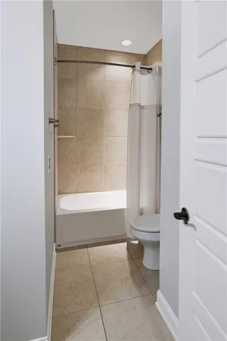 Tub/Shower in Secondary Bathroom with floor to ceiling tile surround.