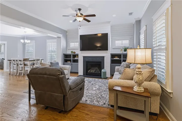 Gas log fireplace with horizontal shiplap to ceiling.