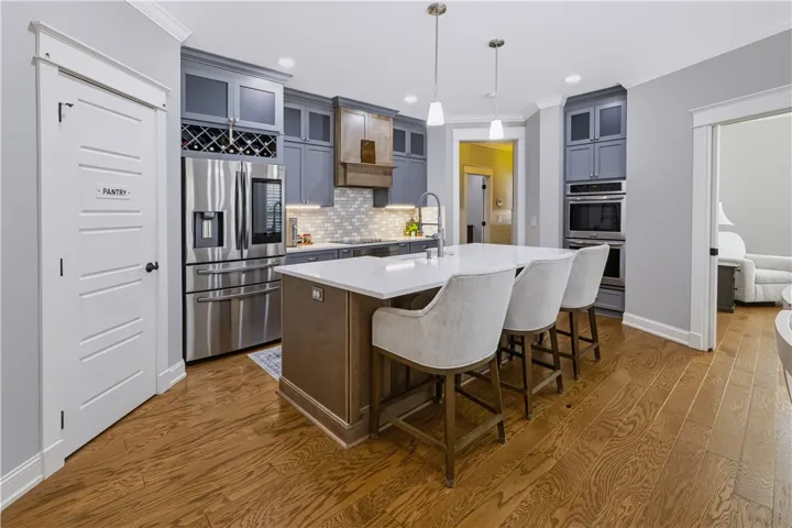 Updated kitchen with ceiling height cabinetry, ample storage space & quartz countertops!