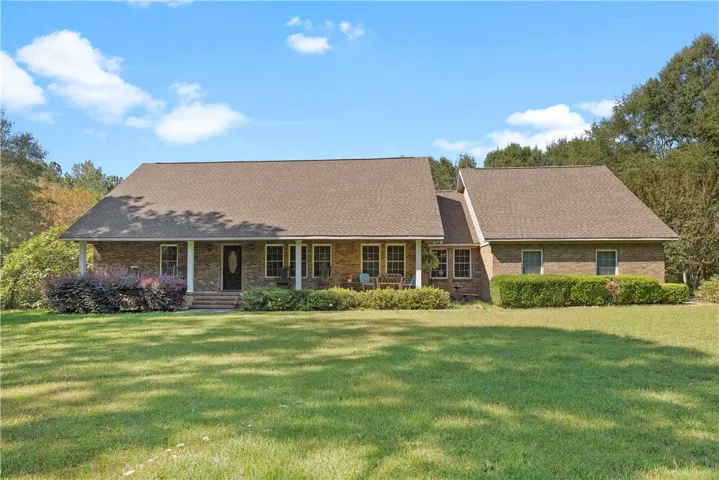 A classic brick exterior and a wide front porch define this timeless ranch-style home.
