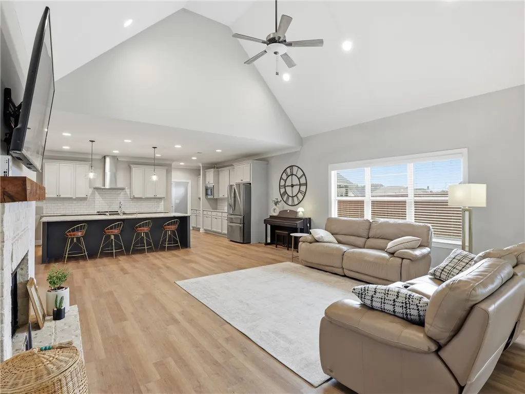 Soaring vaulted ceilings and rich wood floors anchor this open concept main living area.
