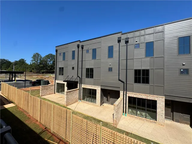 Modern multi-level architecture showcases clean geometric siding paired with classic brick accents.