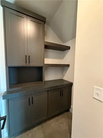 Custom built-in cabinetry and floating shelves maximize storage in this architectural alcove.