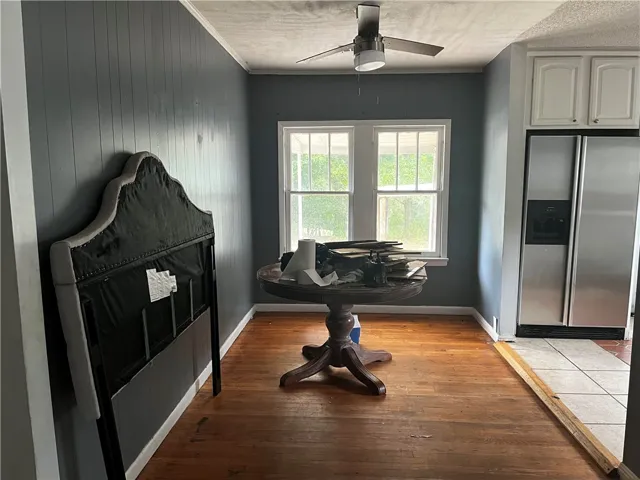 Gleaming hardwood floors flow throughout this flexible dining space highlighted by natural light.