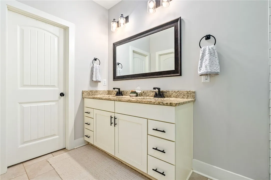 Primary bath double vanity with granite tops.