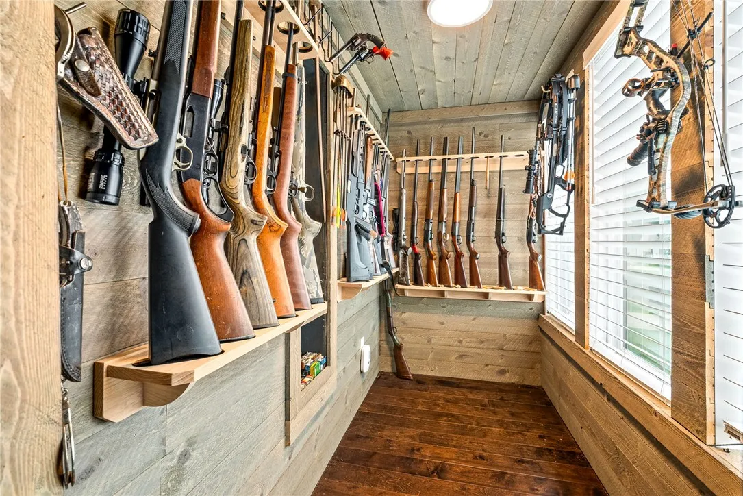 Walk-in storage room with plank walls and wall racks.