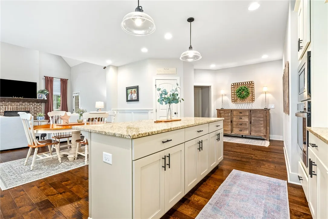 Kitchen island with pendant lights, open to the living room.