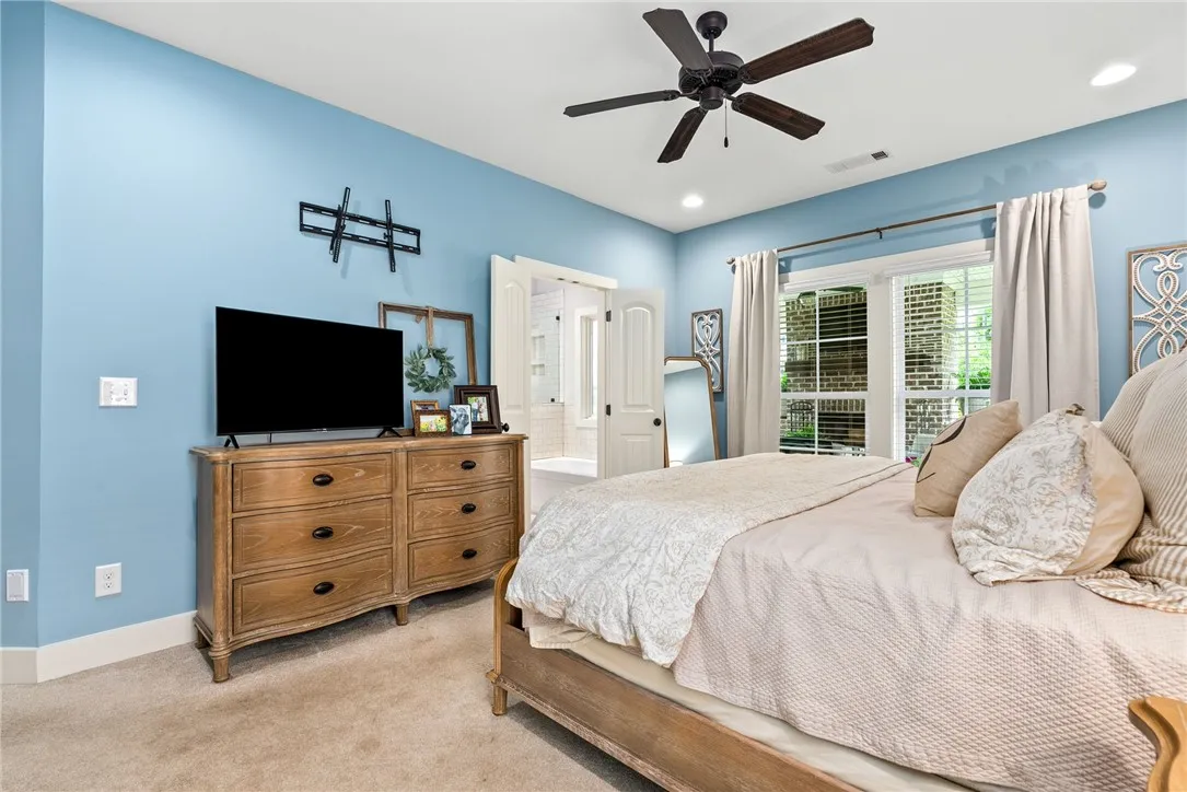 Another view of the primary bedroom, with space for a dresser and TV.