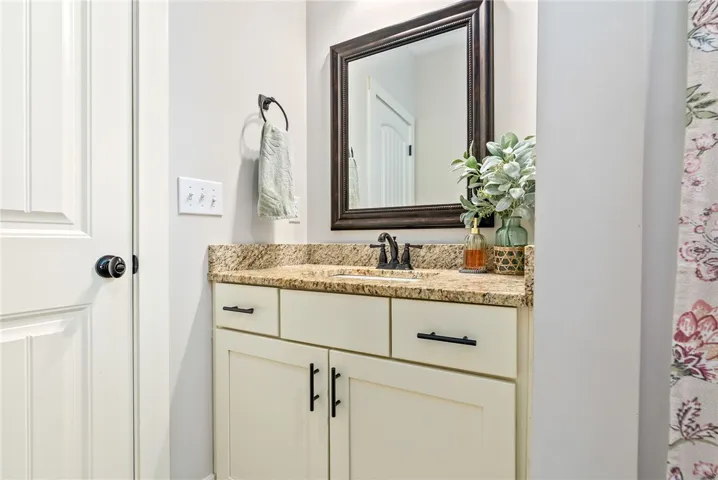 Guest bath vanity with granite top and plenty of storage.