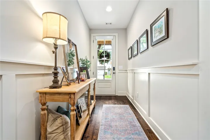 Entry hall with hardwood floors and wainscoting.