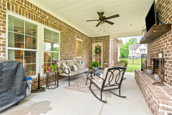 Patio seating area with views of the​​‌​​​​‌​​‌‌​‌‌​​​‌‌​‌​‌​‌​​​‌​​ backyard.