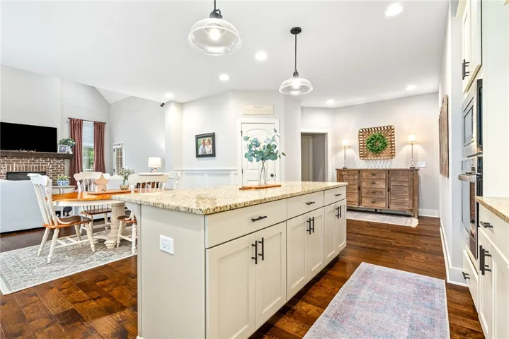 Kitchen island with pendant lights, open to the living room.