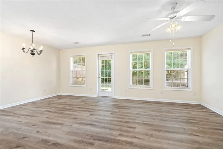 Clean lines and durable plank flooring define this versatile main living area.
