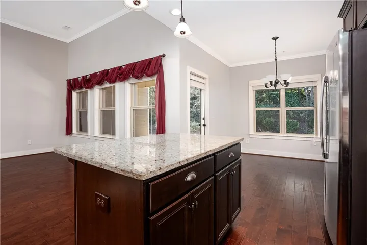 Gleaming hardwood floors run through this open layout featuring granite counters and vaulted ceilings.