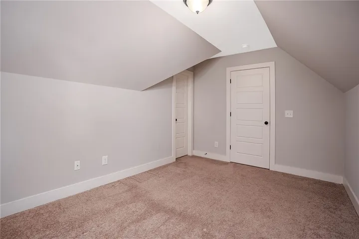 Slanted ceilings and plush carpeting define this versatile upper-level room.