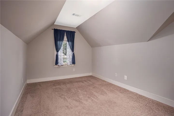 Angled ceilings and soft carpeting create a cozy atmosphere in this quiet upstairs space.