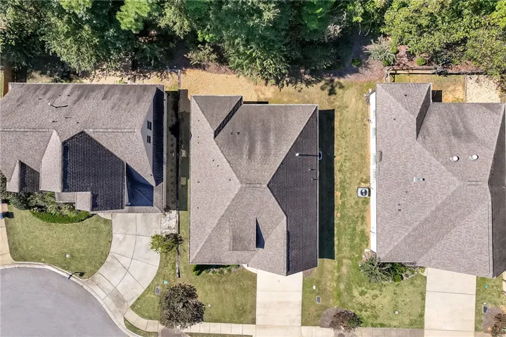 An aerial perspective captures the architectural layout of the home nestled alongside neighboring properties.