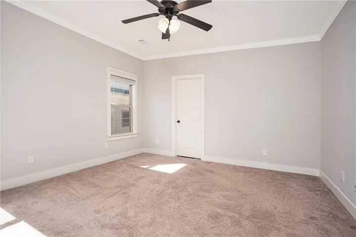 Crown molding and soft carpeting elevate this versatile space.