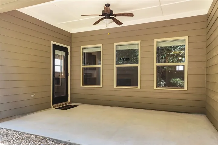 A sheltered concrete outdoor space features lap siding and clean architectural lines.
