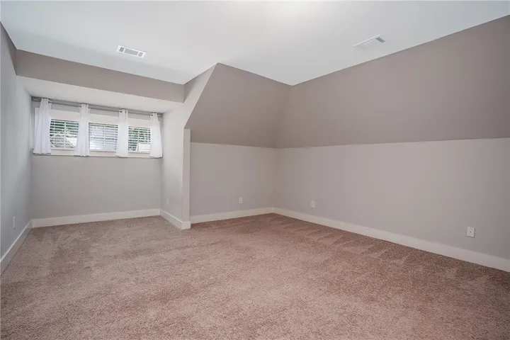 Plush carpeting and unique angled ceilings define this versatile upper-level bonus space.