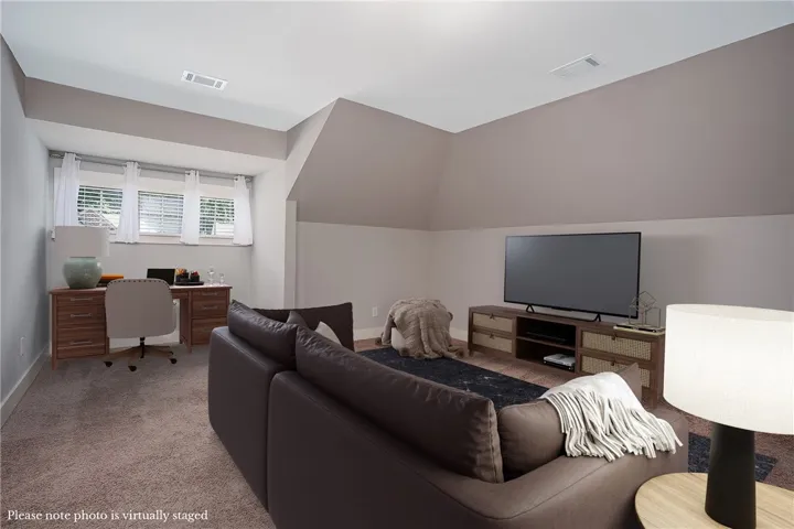 Angled ceilings and soft carpeting define this versatile upper-level living space.