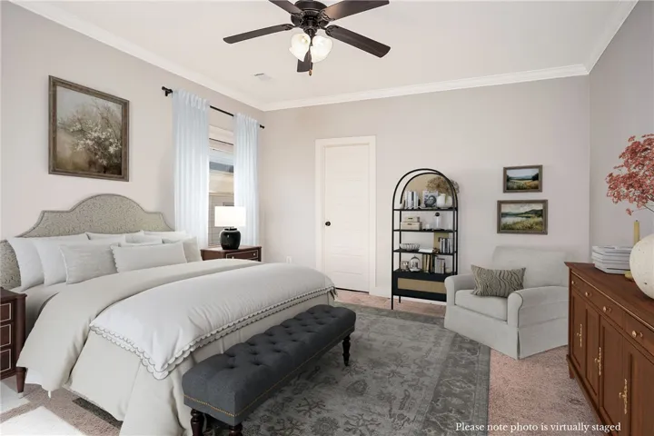 Crown molding and plush carpet enhance this comfortable private retreat.