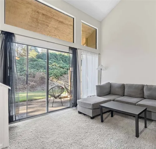 High vaulted ceilings and glass doors connect the interior spaces seamlessly to the outdoors.