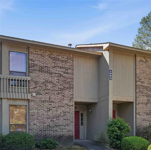 A classic brick and vertical siding facade defines this multi-level exterior entryway.