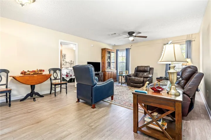 An inviting open floorplan connects the living spaces over durable wood-look laminate flooring.