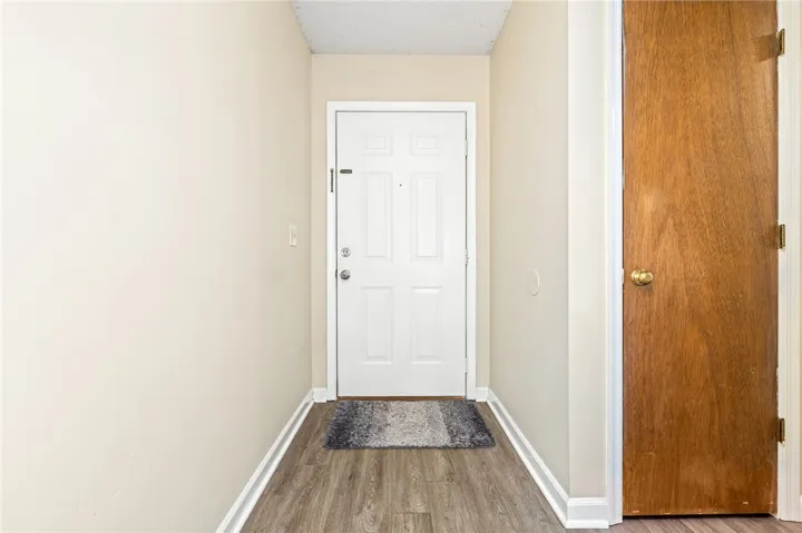 A welcoming entryway transitions seamlessly into the home with durable wood-look flooring and neutral walls.