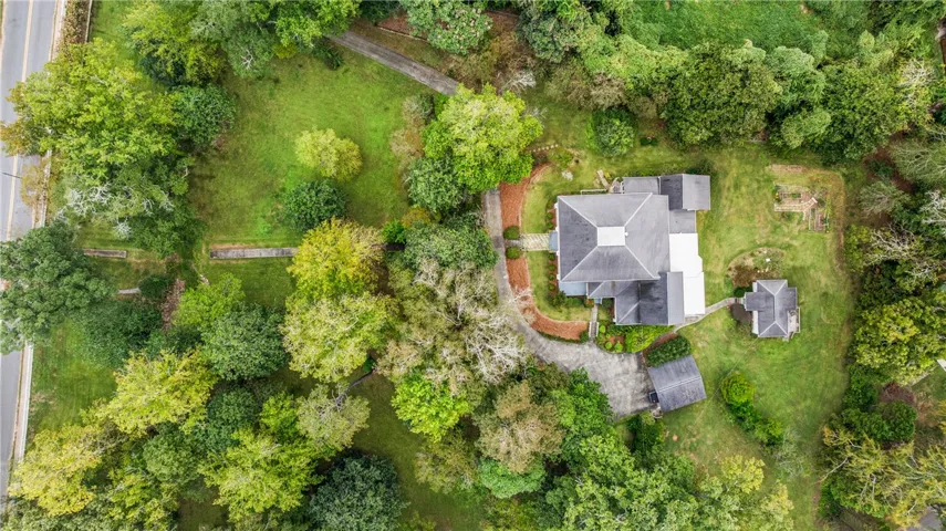 An aerial perspective showcases the private estate enveloped by mature trees and expansive green lawns.
