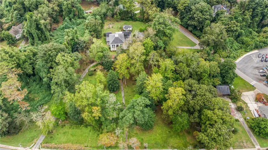 Mature trees surround this expansive property nestled in a serene wooded landscape.