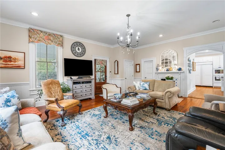 Gleaming hardwood floors and classic crown molding anchor this welcoming living area.