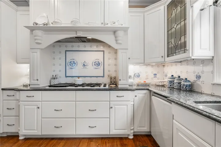 Elegant granite countertops and classical cabinetry define this timeless kitchen space.