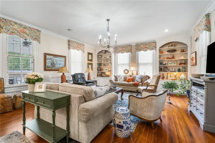 Gleaming hardwood floors and classic built-in bookcases anchor this comfortable living area.