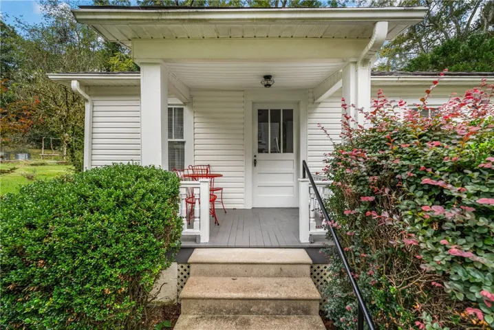 A classic covered front porch with simple wood columns welcomes guests to this charming home.