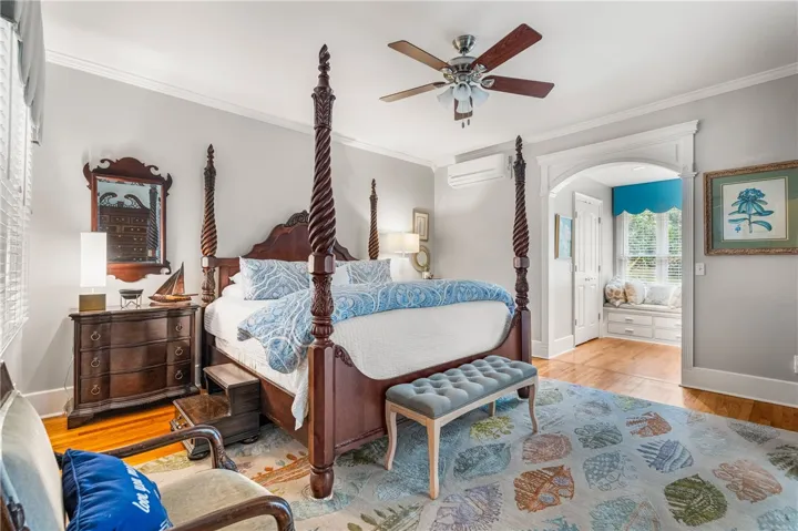 Gleaming hardwood floors and classic crown molding define this elegant bedroom suite.