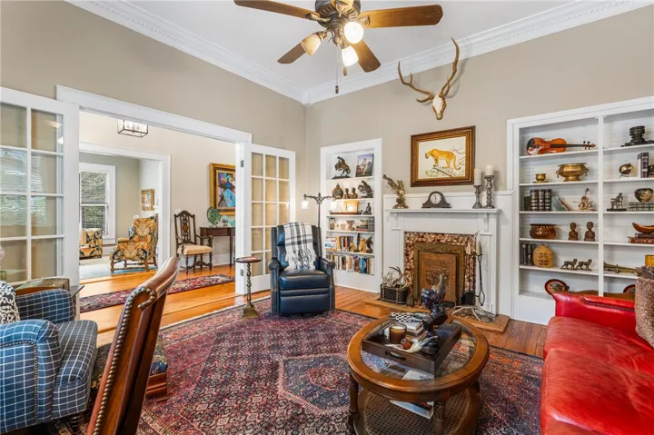Gleaming hardwood floors and a classic fireplace define this elegant, well-crafted living space.
