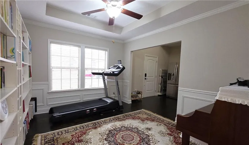 Elegant crown molding, wainscoting, and tray ceilings define this versatile interior space.