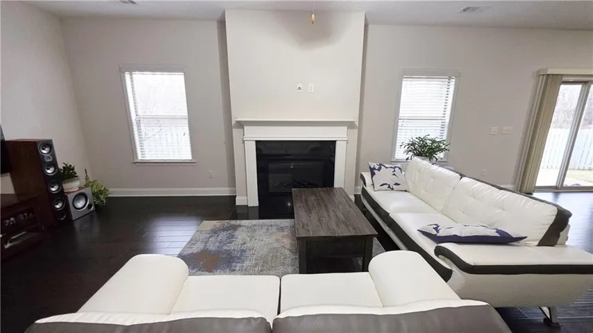 Gleaming hardwood floors and a classic fireplace anchor this open living room layout.