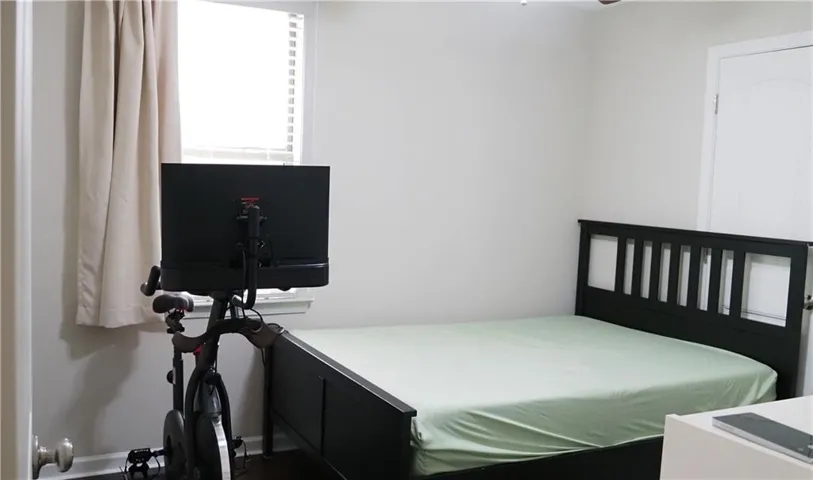A versatile secondary bedroom offers clean walls and a standard window overlooking the exterior.
