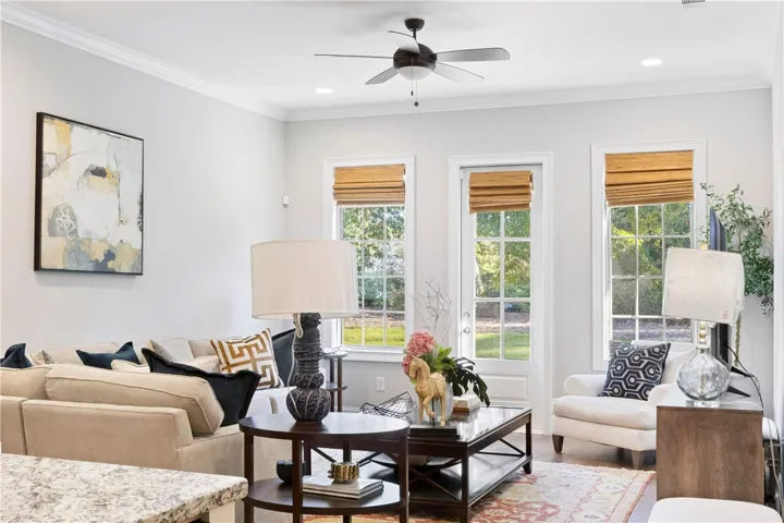 Gleaming hardwood floors and classic crown molding frame this elegant, light-filled living area.
