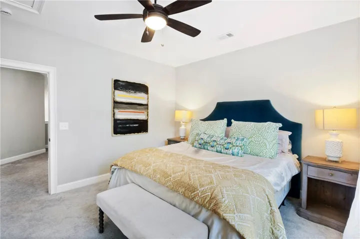 Plush wall-to-wall carpeting and clean trim-work anchor this restful bedroom retreat.
