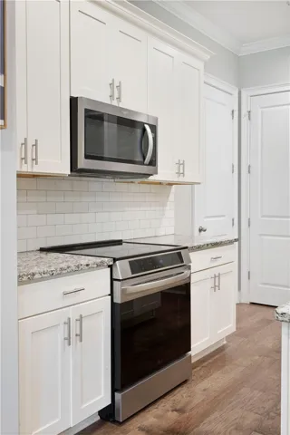Gleaming stone countertops and classic shaker cabinetry define this modern kitchen prep space.