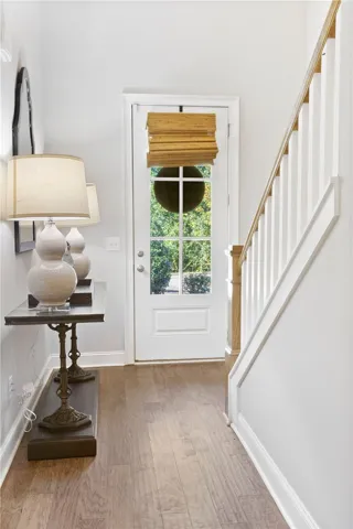 Hardwood floors and a classic staircase welcome visitors inside the front entry.