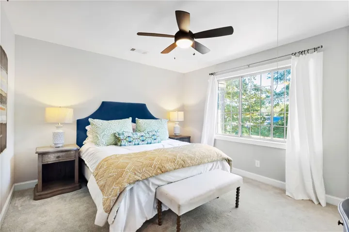 Plentiful natural light streams through a large window overlooking the yard.