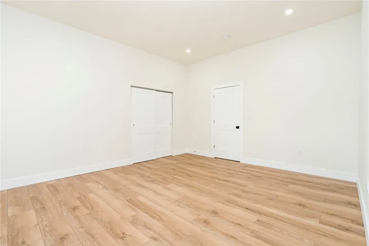 Smooth plaster walls and warm wood-finish flooring define this versatile interior space.